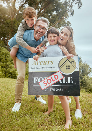 Parents, kids and property with sold sign, portrait and smile for new home, start and investment for future. Father, mother and boy children with sale poster, real estate investing and family houseの写真素材