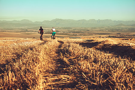 Every day should be an adventure. two cyclists out cycling in the countryside.の写真素材