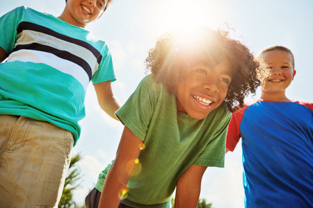 Good friends, good times. a group of diverse and happy kids hanging out together on a bright day outside.の写真素材