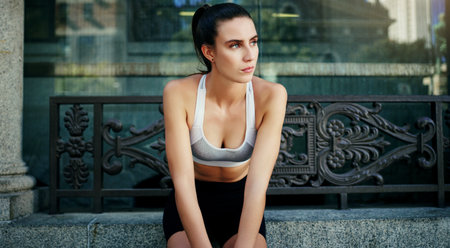 Set goals and figure out a way to get them. a young woman taking a break from her workout in the city.の写真素材