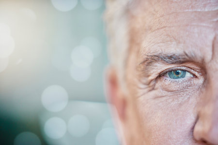 Retina, vision and mockup with blue eye of old man for focus, optometry and healthcare. Iris, human and awareness with senior male and pupil for sight, natural and ophthalmology on bokeh backgroundの写真素材