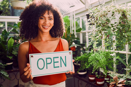 Plant shop, open sign and portrait of a woman with a small business standing in her retail nursery....