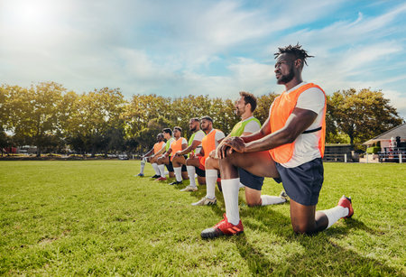 Sports, training and team outdoor for rugby on a grass field with men doing knee exercise. Athlete...
