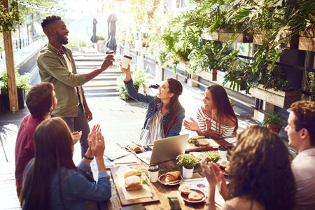 Applause, restaurant and happy business people in lunch meeting for discussion, planning and victory. Cafe, teamwork success and men and women clapping for winning, collaboration and achievementの写真素材