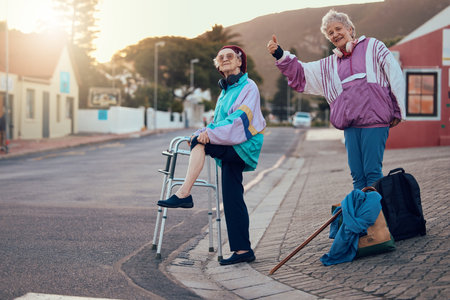 Hitchhiking, disability and travel with senior friends standing on a corner looking for a trip with a hand sign or gesture. Transport, road and handicap with a mature woman and friend hitching a rideの写真素材
