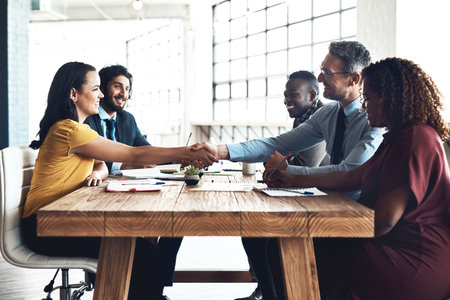 Business people, handshake and staff deal in meeting with agreement and contract collaboration. Partnership, success and b2b work with shaking hands to welcome and show congratulations from teamworkの写真素材