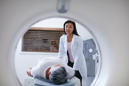Doctor, mri and woman with patient in hospital ready to start scanner machine. Ct scan, examination and medical professional with senior person before cancer radiology test for healthcare in clinic.の写真素材