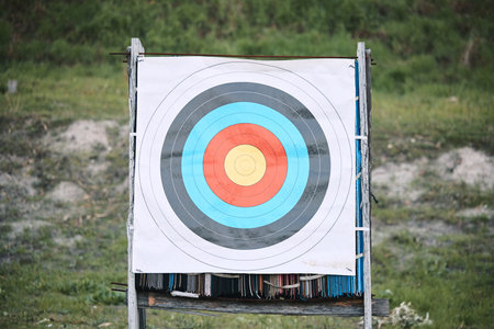 Bullseye target paper, outdoor and board at shooting range for weapon training, aim and accuracy. Sports, archery and poster for gun, bow and arrow at academy for police, army or security for goalの写真素材