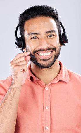 Portrait, call center and customer service with a man consultant in studio on a gray background....