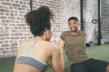 Did you enjoy your workout. two sporty young people having a conversation while sitting together at the gym.の写真素材