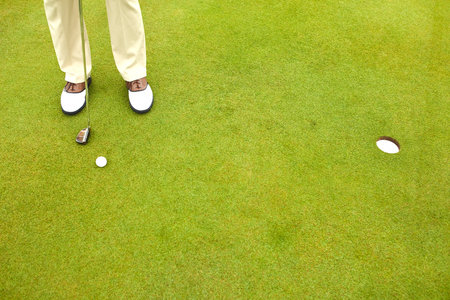 Life is better on the green. a mature man out playing golf in his free time.