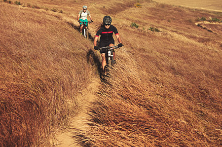 She a ride or die kinda girl. two cyclists out cycling in the countryside.