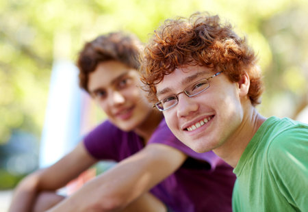 Portrait, children and friends in a park together during summer for bonding outdoor on holiday. Friendship, kids or boys with a young child and best friend outside in the day on a blurred backgroundの写真素材