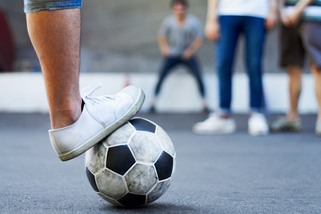 Soccer ball, closeup and foot with exercise, fitness and competition with training, workout and health. Zoom, feet and team with match, football and sports with shoes, growth and athlete in a gameの写真素材