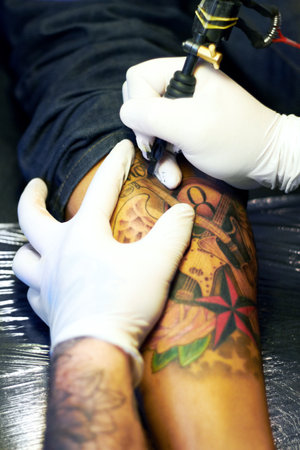Arm, hands or tattoo artist drawing for body art, design and creativity in ink parlor shop for unique tattoos. Culture, closeup or creative designer holding a needle machine for tattooing a personの写真素材