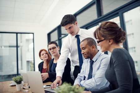 Technology has driven a great amount of change to business. group of businesspeople using a laptop...
