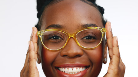 Black woman, vision and glasses, face and fashion, designer frame and fun, prescription lens isolated on white background. Happy female, laugh and pose in portrait with optometry, style and eye careの写真素材