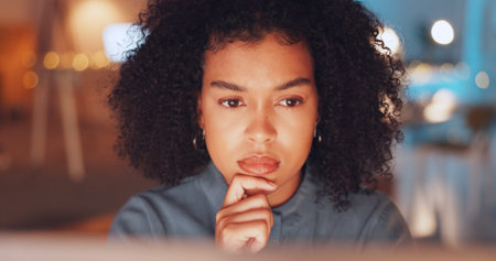 Night, thinking and computer with black woman in office for research proposal, project and...
