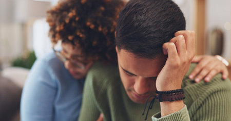 Support, empathy and care with sad couple at home, woman comforting depressed man in living room....