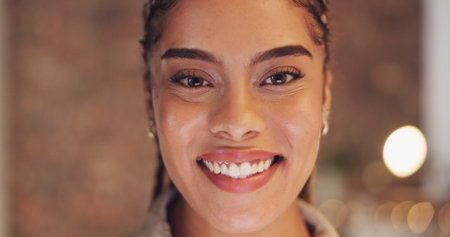 Night, happy and smile with black woman in office for overtime, confidence and professional. Pride, deadline and business with portrait of employee in agency for positive, empowerment and commitmentの写真素材