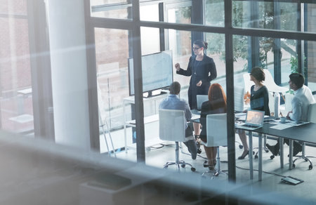 Presenter, teaching or business people in presentation for sales report, vision or data analysis in mentorship. Leadership, group or manager planning strategy on screen monitor in training or meetingの写真素材