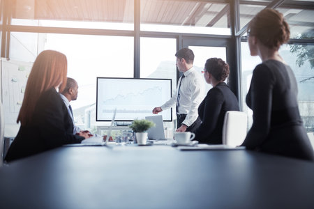 Presentation, proposal and team in a meeting for a report or corporate workshop for sales in a startup company. Board, manager and business man or speaker talking about growth or development strategyの写真素材