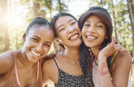 Friends, camping and women in selfie, adventure and happy, travel with diversity and group bonding in nature. Summer, fun and happiness, female people smile in picture with memory and relax outdoorの写真素材