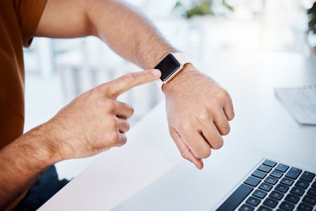 Time check, work and hands of a man with a watch for a notification, reading information or email. Business, busy and arm of a businessman checking a digital clock while working on a laptop in officeの写真素材