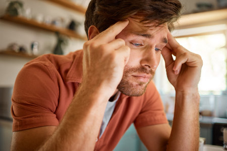 Thinking, Headache and business man in kitchen for remote work, freelancer and mental health. Glitch, tired and frustrated with male person and massage at home for burnout, exhausted and anxietyの写真素材