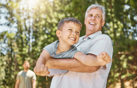 Hiking, family and a boy flying with his grandfather outdoor in nature while camping in the forest...
