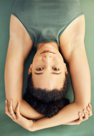 Happy woman, yoga and lying on mat for exercise, stretching body or workout above at home. Top view portrait of female person, face or yogi in warm up or pose for spiritual wellness or awarenessの写真素材