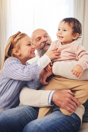 Grandfather, children and play with happiness, home and cheerful with fun, bonding and loving together. Senior man, siblings or kids in a living room, chilling and love on a weekend break and excitedの写真素材