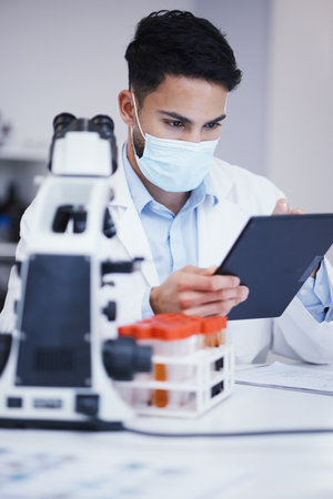Blood test, tablet and scientist man with research analysis, vaccine and healthcare, face mask and laboratory data. Medical, science doctor or person with digital technology for covid or dna resultsの写真素材