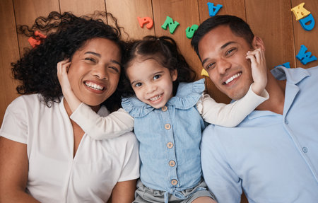 Happy, love and above portrait of a family with care, relax and bonding together on the lounge floor. Smile, fun and a child with affection for parents in the living room in a house for playingの写真素材