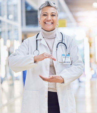 Hospital, doctor and portrait of woman with hand shape for wellness, medical service and insurance in clinic. Healthcare, cardiology and happy female health worker with gesture for innovation mockupの写真素材