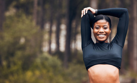 Stretching, fitness and portrait of black woman in nature for exercise, training and sports in forest. Mockup, mountain and happy female person stretch arms for warm up, cardio workout and wellnessの写真素材