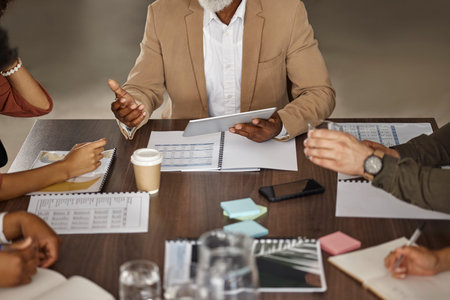 Documents, tablet or hands of business people in a meeting planning a financial strategy together....
