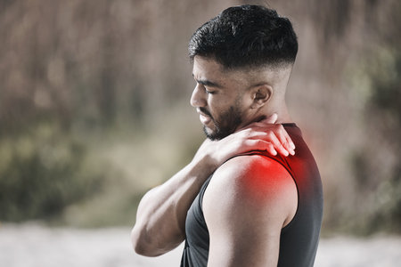 Shoulder pain, red and man in fitness or workout injury, sports risk or muscle healthcare in nature. Medical, neck or stress of athlete person massage for training, cardio or exercise problem overlayの写真素材