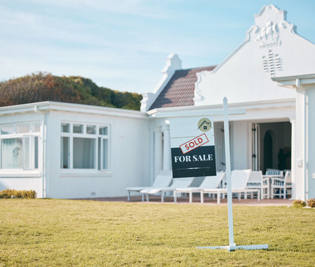 Real estate, house sold and with sign or poster on green lawn. Property or investment sale, mortgage or modern architecture and empty new home. Outdoor or building, moving board and relocationの写真素材