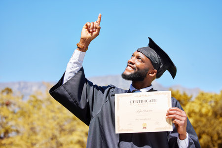 Certificate, graduation and success with black man pointing for award, winner and education. Scholarship, future and learning with university student on campus for achievement, study and diplomaの写真素材