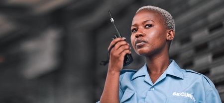 Security, radio and a black woman police officer in the city during her patrol for safety or law enforcement. Walkie talkie, communication and service with a female guard on a street in an urban townの写真素材