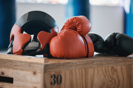 Gym, equipment and helmet with gloves for boxing fitness, commitment and inspiration in sports training. Kickboxing tools, safety and security in fight exercise, competition goals and fit motivation.の写真素材