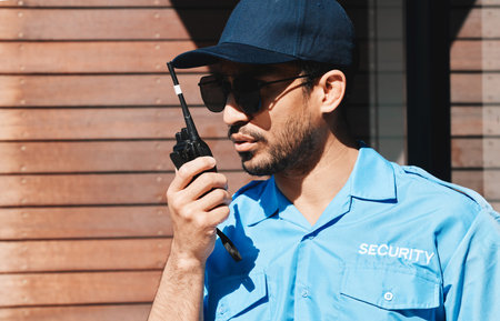 Security guard, walkie talkie and safety officer man outdoor for protection, patrol and...