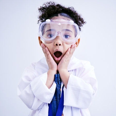 Child, shocked and science portrait with glasses in studio with open mouth, wow or surprised face. African kid student excited for education or biology experiment and learning for future scientistの写真素材