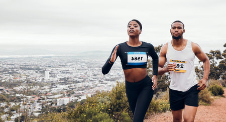 Marathon couple, mountain race and fitness with workout and training together for a running. Runner, young people and road on a exercise challenge outdoor with sport cardio performance in natureの写真素材