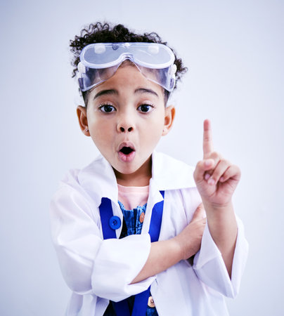 Child, hand and idea or solution for science in studio with mouth open, glasses and thought. Face of a African kid student shocked or wow for scientist, education or biology experiment for innovationの写真素材