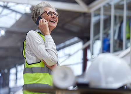 Phone call, senior woman and architect in funny conversation, planning and work on construction...