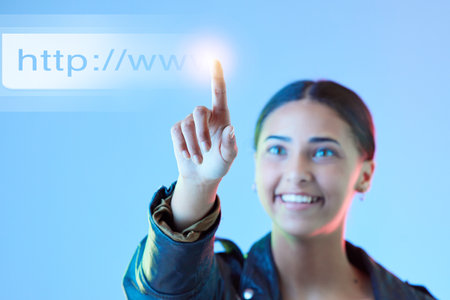 Hologram, futuristic and woman typing, link and connection against a blue studio background. Female person, employee or holographic with data analytics, cloud computing or programming with url or webの写真素材