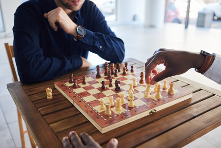 Hands, competition and people with a chess game, strategy and playing together for fun. Table,...