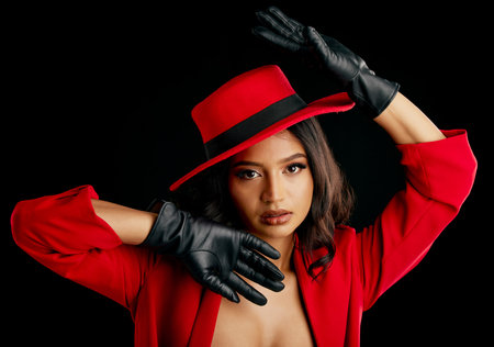 Woman, retro spy and glamour art portrait in studio with vintage fashion and cosplay agent. Young female person, black background and luxury style with cosmetics, clothes and model with confidenceの写真素材